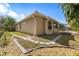 Exterior view of the home with a well-maintained yard and patio at 5549 Eastwind Dr, Sarasota, FL 34233