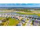Expansive aerial view showcases a residential community with lakeside homes and beautifully maintained green spaces at 5617 Flagstone Trl, Palmetto, FL 34221