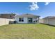 Large, well-maintained backyard featuring green lawn, secure fencing, and views of the home's exterior at 5617 Flagstone Trl, Palmetto, FL 34221