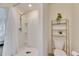 Bathroom featuring a walk-in shower, toilet, and decorative shelving unit at 5617 Flagstone Trl, Palmetto, FL 34221