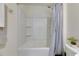 Bathroom with a tub shower, grab bar, and decorative greenery at 5617 Flagstone Trl, Palmetto, FL 34221