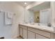 Bathroom featuring a double sink vanity with modern fixtures, large mirror, and white cabinets at 5617 Flagstone Trl, Palmetto, FL 34221