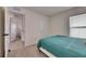 This cozy bedroom features soft carpeting, a comfortable bed, and natural light from the window at 5617 Flagstone Trl, Palmetto, FL 34221