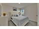 Cozy bedroom with a queen bed, soft bedding, and natural light from the window at 5617 Flagstone Trl, Palmetto, FL 34221