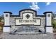 A stone entrance sign for Silverstone neighborhood with a decorative fountain and manicured landscaping at 5617 Flagstone Trl, Palmetto, FL 34221