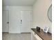 Clean entryway with tiled floor, white door, and console table with decorative items at 5617 Flagstone Trl, Palmetto, FL 34221