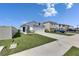 Street view of house featuring a well-manicured lawn and driveway at 5617 Flagstone Trl, Palmetto, FL 34221