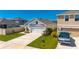 Charming single-story home featuring a two-car garage, well-manicured lawn, and inviting curb appeal at 5617 Flagstone Trl, Palmetto, FL 34221