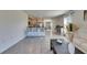 Modern kitchen with stainless steel appliances and bar seating, adjacent to living area at 5617 Flagstone Trl, Palmetto, FL 34221