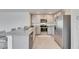 Contemporary kitchen with gray cabinets, stainless steel appliances and a granite countertop breakfast bar at 5617 Flagstone Trl, Palmetto, FL 34221