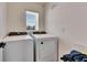 Convenient laundry area with modern, matching washer and dryer under a bright window at 5617 Flagstone Trl, Palmetto, FL 34221