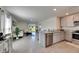 Modern open-concept living space flows into the kitchen with sleek stainless steel appliances at 5617 Flagstone Trl, Palmetto, FL 34221