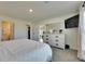 Bright main bedroom boasts a large bed, TV, dresser, closet, and en-suite bathroom at 5617 Flagstone Trl, Palmetto, FL 34221