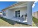 Relax on the covered patio with seating and a grill, extending your living space outdoors at 5617 Flagstone Trl, Palmetto, FL 34221