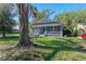 Charming home featuring a classic design, inviting front porch, and well-manicured lawn at 6002 N Branch Ave, Tampa, FL 33604