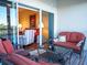 Comfortable balcony seating with picturesque views of the living room and a tranquil waterfront at 6401 99Th N Way # 15C, St Petersburg, FL 33708