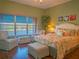 This waterfront bedroom has a relaxing seating area and tropical decor at 6401 99Th N Way # 15C, St Petersburg, FL 33708