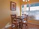 Cozy dining area with a wooden table, four chairs, and a window with natural light at 6401 99Th N Way # 15C, St Petersburg, FL 33708