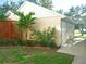 View of the home's exterior, highlighted by decorative plants and a lush green lawn at 6401 99Th N Way # 15C, St Petersburg, FL 33708