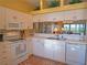 Bright kitchen featuring white cabinets, modern appliances, and a view into the living area at 6401 99Th N Way # 15C, St Petersburg, FL 33708