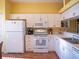 Well-lit kitchen featuring white cabinetry, modern appliances, and ample counter space at 6401 99Th N Way # 15C, St Petersburg, FL 33708