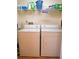 The laundry room is equipped with a washer and dryer and storage shelves at 6401 99Th N Way # 15C, St Petersburg, FL 33708