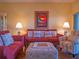 This living room offers a comfortable seating arrangement with sofas, an ottoman, and tasteful decorations at 6401 99Th N Way # 15C, St Petersburg, FL 33708