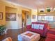 Inviting living room with comfortable seating, wood floors, and view to the dining area and hall at 6401 99Th N Way # 15C, St Petersburg, FL 33708