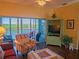 Charming living room leading to a balcony offering beautiful water views, ample seating, and natural light at 6401 99Th N Way # 15C, St Petersburg, FL 33708