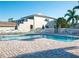 Community pool with plenty of lounge chairs and beautiful landscaping at 6401 99Th N Way # 15C, St Petersburg, FL 33708