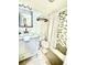 Updated bathroom featuring modern vanity, toilet, and shower with beautiful tile backsplash and shower curtain at 712 Beach Trl # C, Indian Rocks Beach, FL 33785