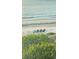 Serene beach view with chairs, offering a tranquil spot to relax and enjoy the waterfront at 712 Beach Trl # C, Indian Rocks Beach, FL 33785