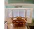Bright dining area featuring wood table and chairs near a large window at 712 Beach Trl # C, Indian Rocks Beach, FL 33785