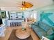 Relaxing living space with dining area, kitchen with bar seating, comfortable seating, and nautical decor at 712 Beach Trl # C, Indian Rocks Beach, FL 33785