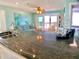 Open living space with granite counters, tile floors, comfortable furniture and ocean views at 712 Beach Trl # C, Indian Rocks Beach, FL 33785