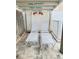 Relaxing outdoor lounge area with two white lounge chairs at 712 Beach Trl # C, Indian Rocks Beach, FL 33785