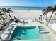 Backyard pool with lounge chairs overlooking the ocean at 712 Beach Trl # C, Indian Rocks Beach, FL 33785