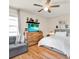 Well-lit bedroom featuring a ceiling fan, closet space, a TV and a comfortable chair at 7320 Los Padres Ct, Tampa, FL 33634