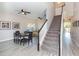 Inviting living room featuring hardwood floors, ceiling fans, neutral walls, and a staircase leading to the upper level at 7352 Cutwater Ln, Wesley Chapel, FL 33545