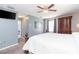 Spacious main bedroom featuring a ceiling fan, television, and an adjoining bathroom with a vanity sink at 7352 Cutwater Ln, Wesley Chapel, FL 33545