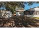 A spacious, partially shaded backyard featuring a storage shed and screened-in porch at 8436 Cameo St, Spring Hill, FL 34608