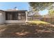 The fenced backyard features a screen porch, pool enclosure, and mature trees at 8436 Cameo St, Spring Hill, FL 34608