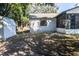 A spacious, partially shaded backyard featuring a storage shed and screened-in porch at 8436 Cameo St, Spring Hill, FL 34608