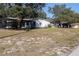 An expansive view of the backyard and the rear exterior of the house at 8436 Cameo St, Spring Hill, FL 34608