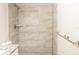 The updated bathroom features modern tile shower, new fixtures and granite topped vanity at 8436 Cameo St, Spring Hill, FL 34608