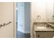 Bathroom featuring modern granite vanity, updated fixtures, and a view into the hall at 8436 Cameo St, Spring Hill, FL 34608