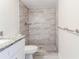 Stylish bathroom with a stand-up shower with decorative tile and a granite countertop at 8436 Cameo St, Spring Hill, FL 34608