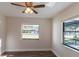 Well-lit bedroom featuring hardwood floors, two windows and a ceiling fan at 8436 Cameo St, Spring Hill, FL 34608