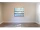Bright and airy bedroom with fresh paint, wood-look floors, and updated window at 8436 Cameo St, Spring Hill, FL 34608