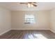 Bright bedroom with a ceiling fan, neutral walls, a window, and attractive wood-look flooring at 8436 Cameo St, Spring Hill, FL 34608